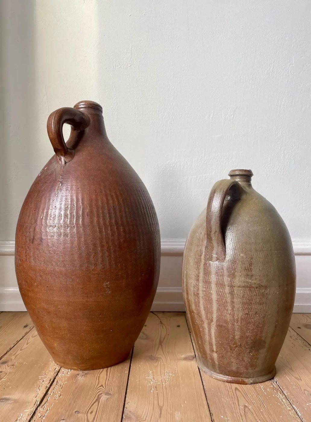 A pair of 19th-century French terracotta jugs in different sizes