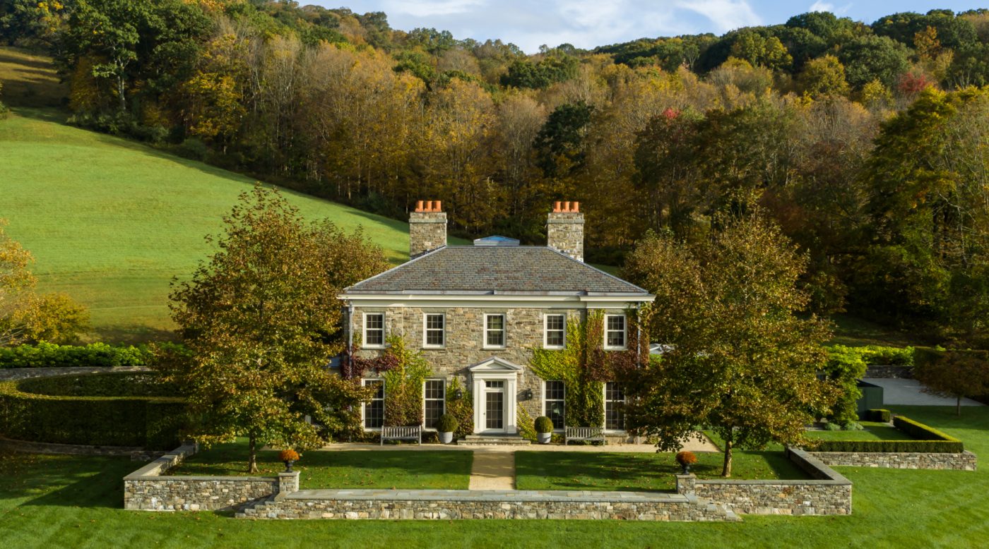 Exterior image of fieldstone-clad Dutchess County New York Regency-style home by Gil Schafer III in his new book Home at Last: Enduring Design for the New American Home Rizzoli publisher written with Mark Kristal