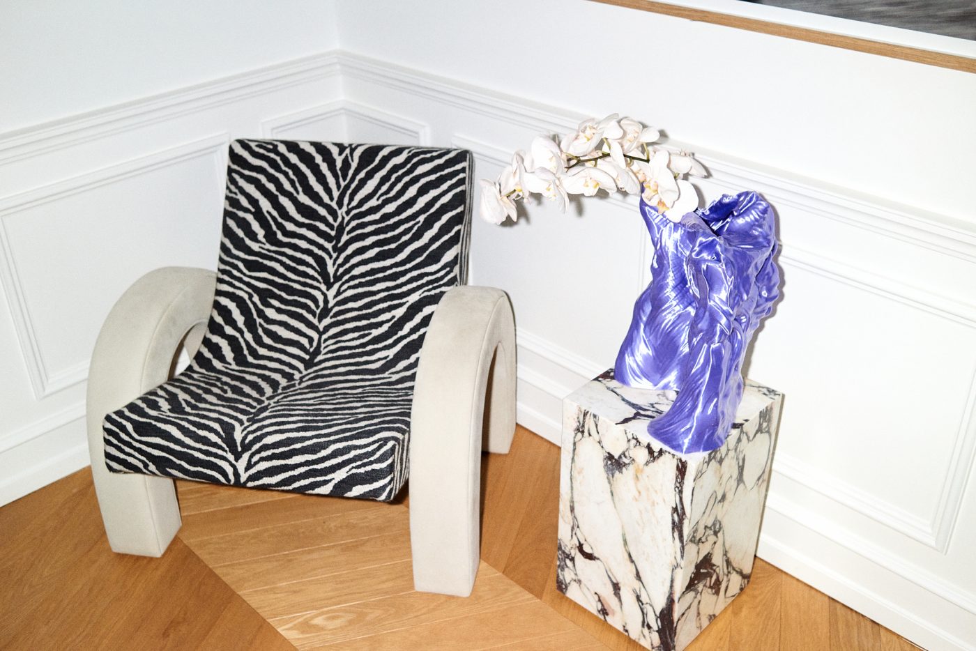 A zebra-print Dusty Deco Arco chair, designed in collaboration with Pernille Teisbaek and pictured in Teisbaek's home office