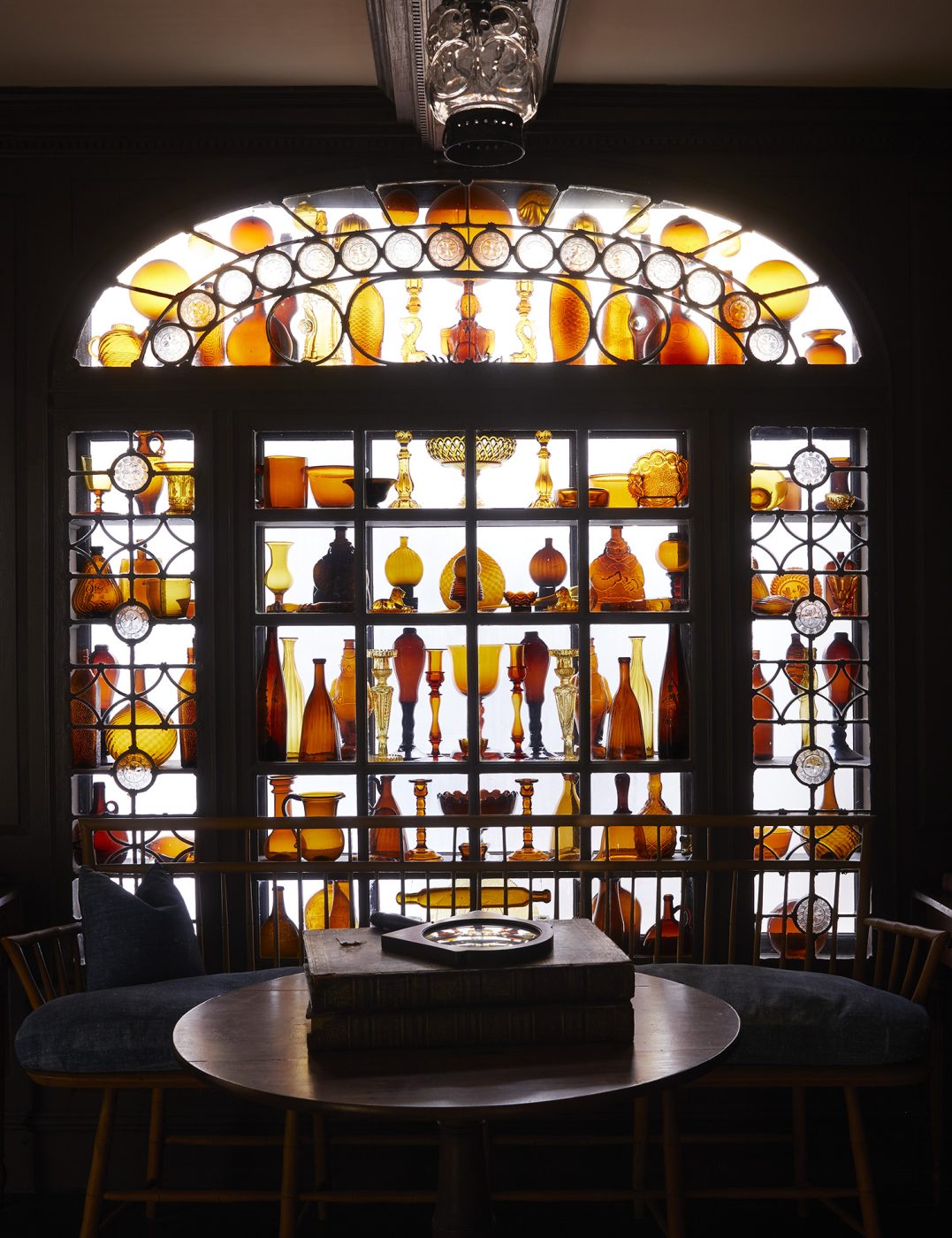 A collection of amber glass in the Stair Hall at Beauport, the Sleeper-McCann House