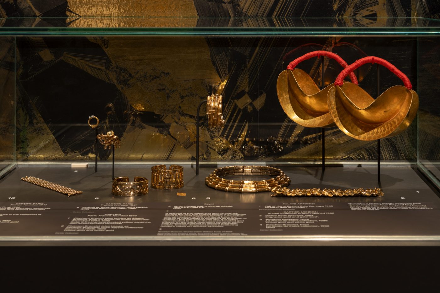 Cartier jewelry and a pair of Fulani earrings on display in the Brooklyn Museum exhibtion "Solid Gold"
