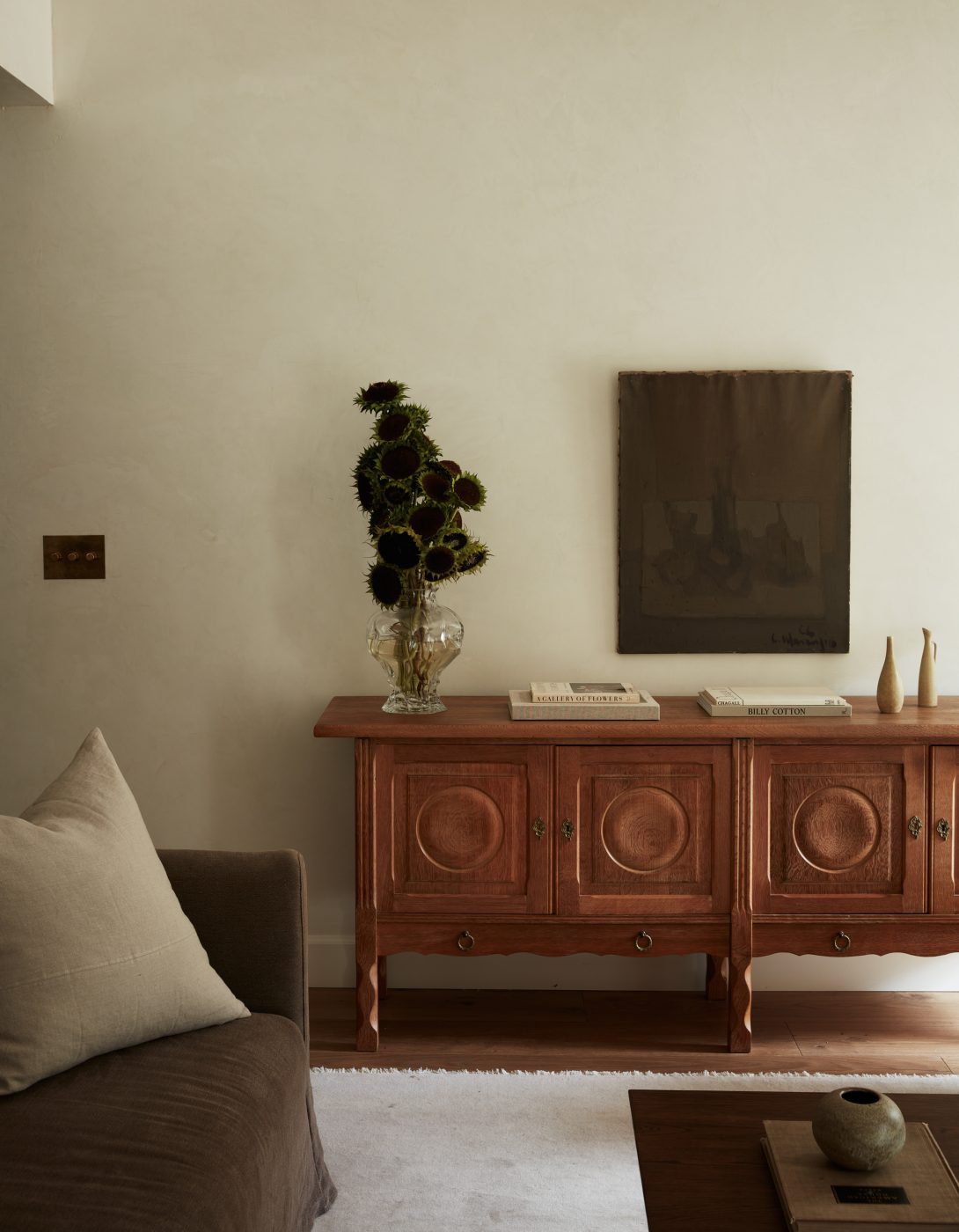Carved wood antique sideboard in living room of interior designer Molly Beth Kidd's Oregon home