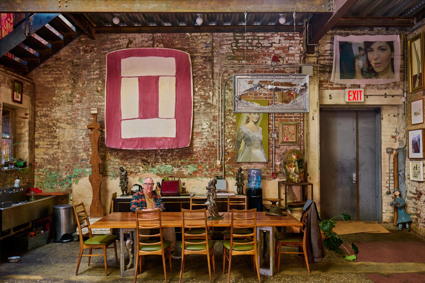 artist Ray Smith sits at the dining table in his home in his Brooklyn studio