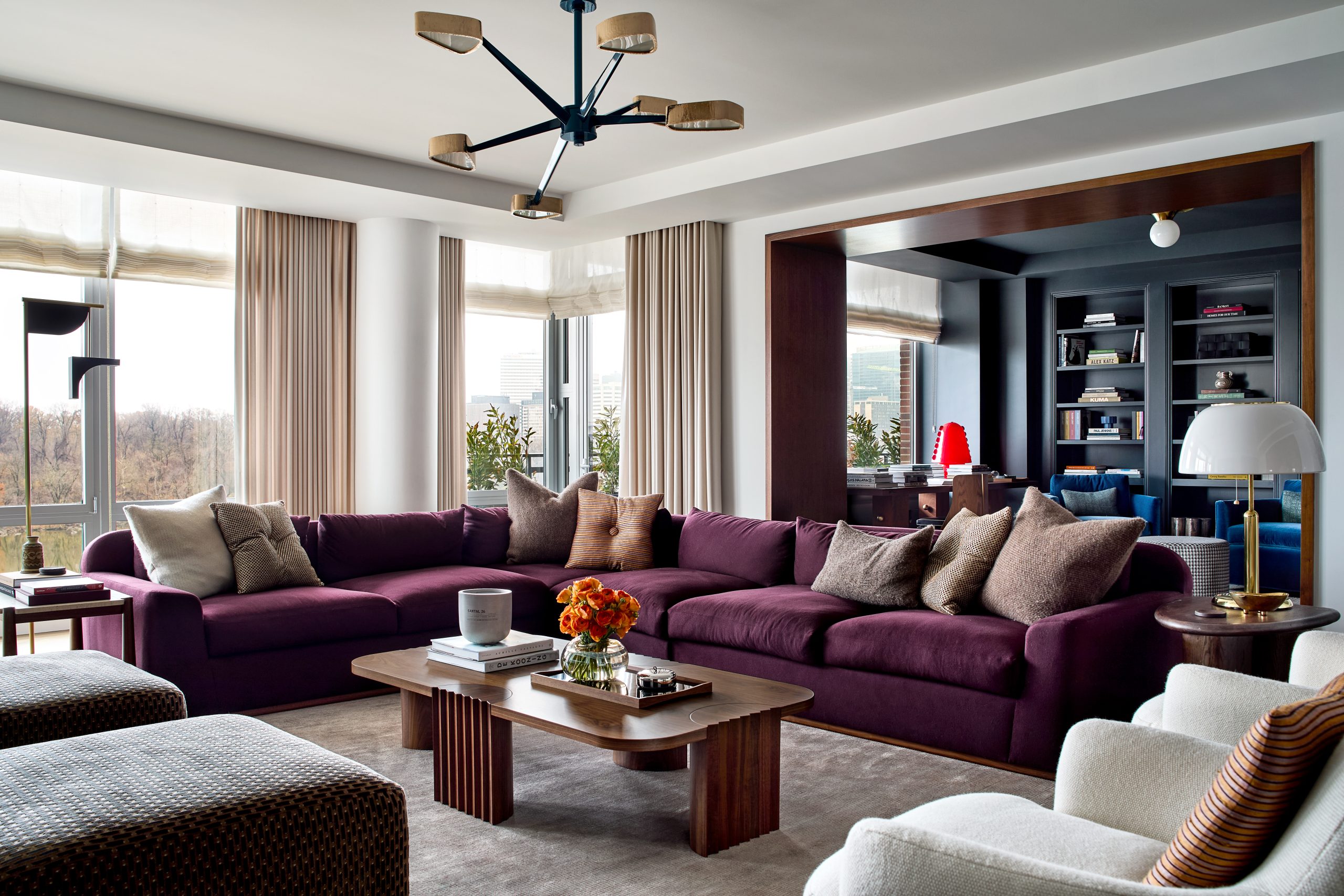 living room with large port-hued section sofa and view to office behind in Washington DC Georgetown penthouse apartment by interior designer Zoë Feldman
