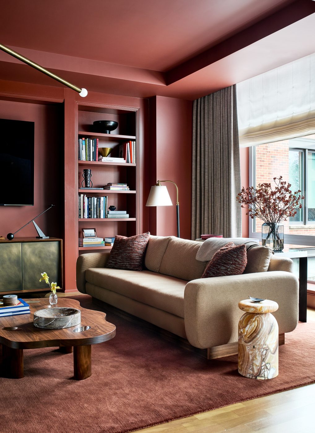 Terracotta-colored den in Washington DC Georgetown penthouse apartment by interior designer Zoë Feldman