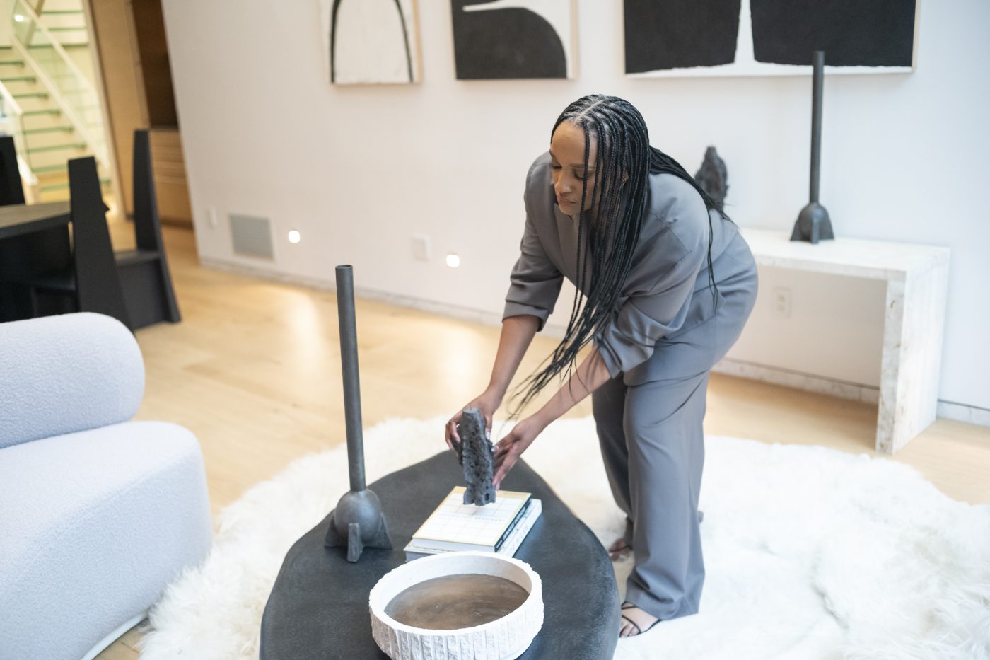 Interior designer Randall Jones placing a Niclas Wolf candlestand on a Kar coffee table at Galerie Philia