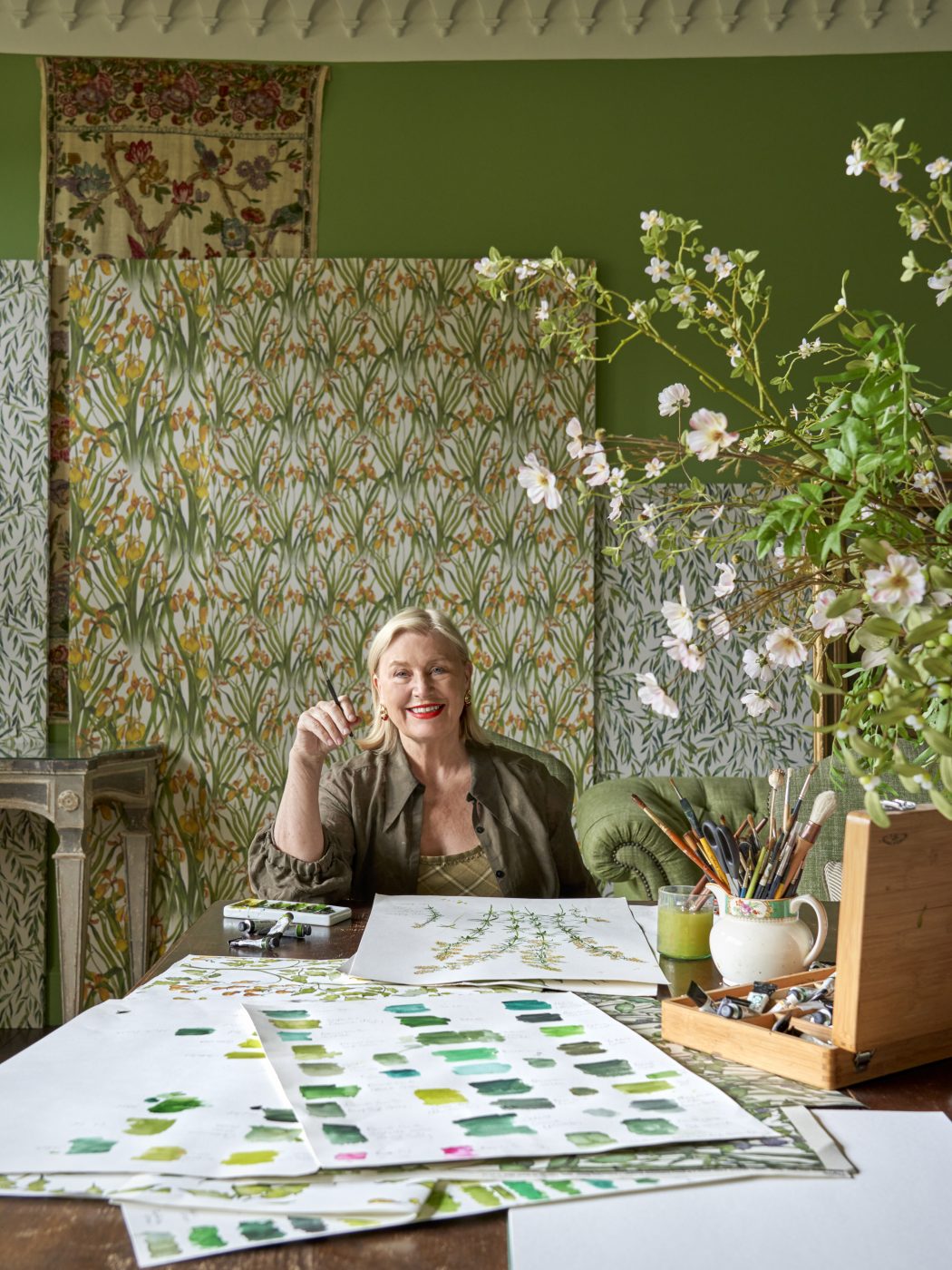 Portrait of Caryn Hibbert founder and designer of Thyme countryside hotel in England's Cotswolds pictured in her art studio painting  botanicals for her Bertioli line of textiles and wallpapers