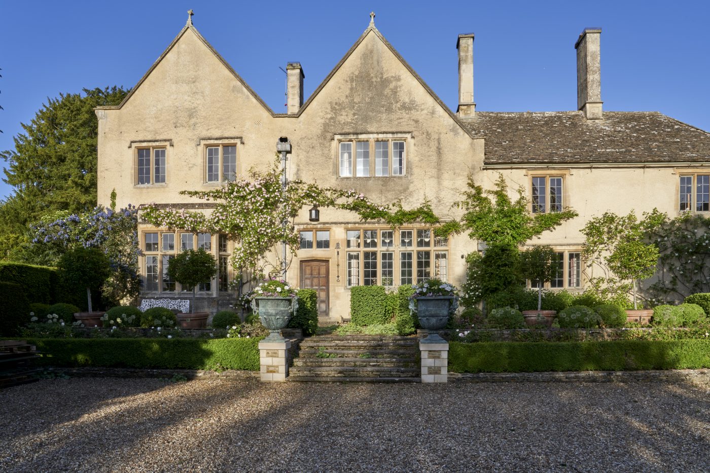 Exterior of the golden-stone-walled Manor House of the Hibbert family, founders of the Thyme countryside hotel and estate in England's Cotswolds 