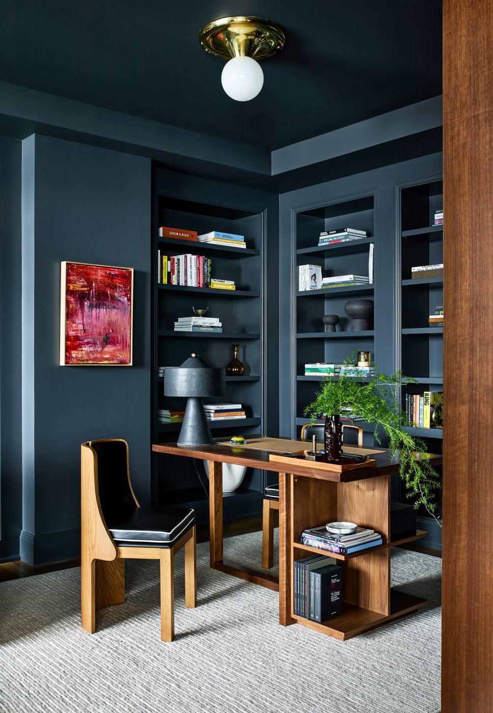 Dark gray office with built-in bookshelves and cantilevered desk in Washington DC Georgetown penthouse apartment by interior designer Zoë Feldman