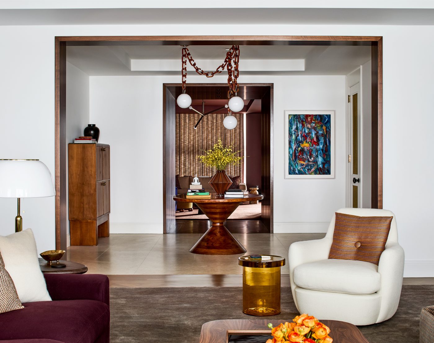 View through living room to entrance gallery and den of Washington DC Georgetown penthouse apartment by interior designer Zoë Feldman