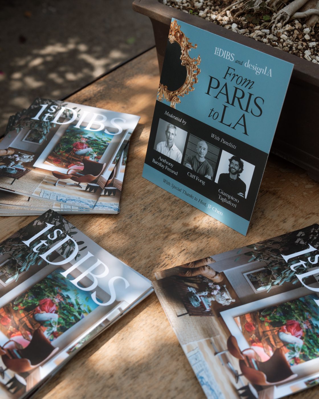 1stDibs catalogues on a table at Los Angeles design gallery JF Chen alongside a sign welcoming attendees to a panel discussion organized by 1stDibs and Design LA