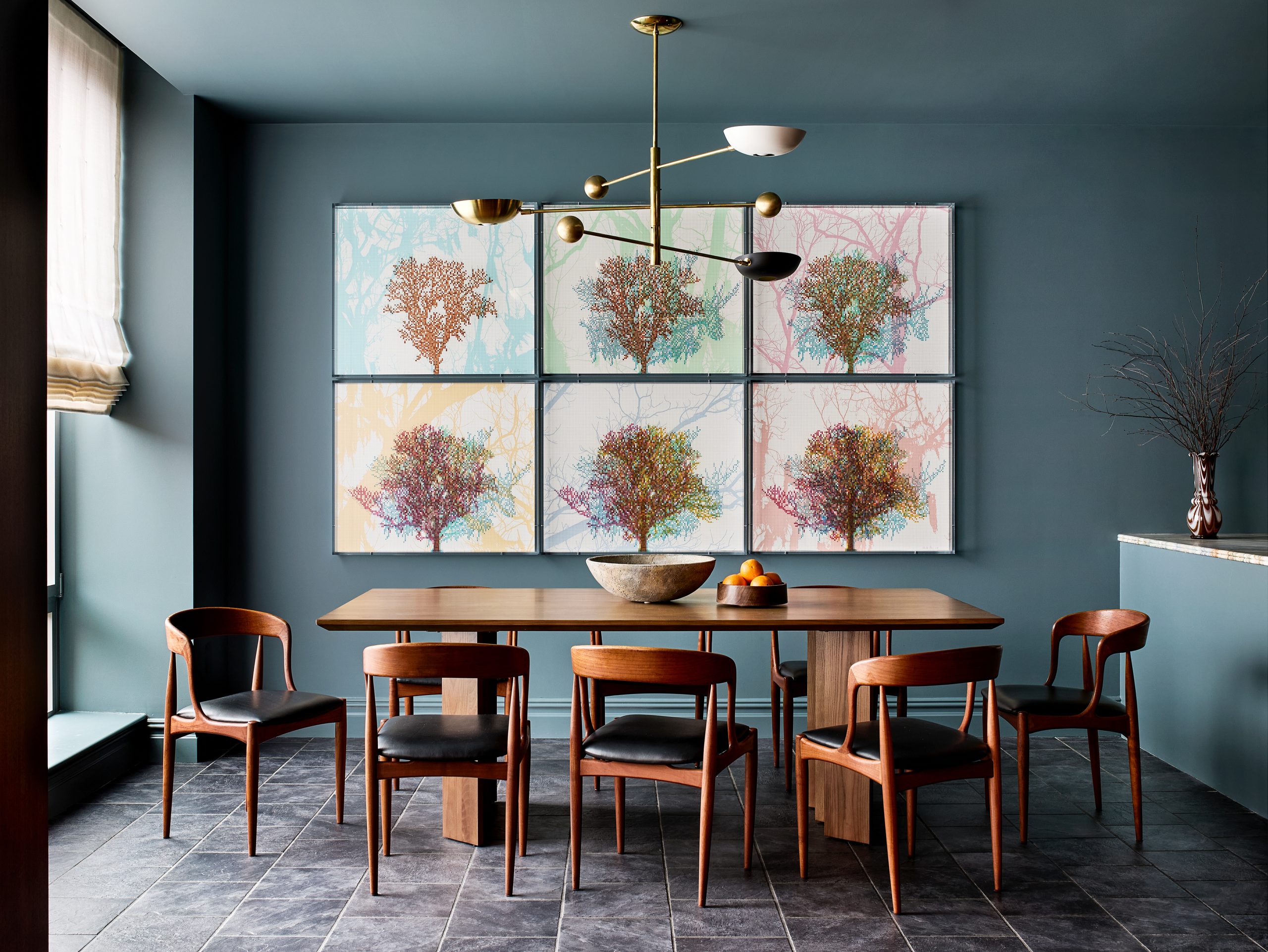 Dining area with series of tree print artworks by Charles Gaines in kitchen of Washington DC Georgetown penthouse apartment by interior designer Zoë Feldman