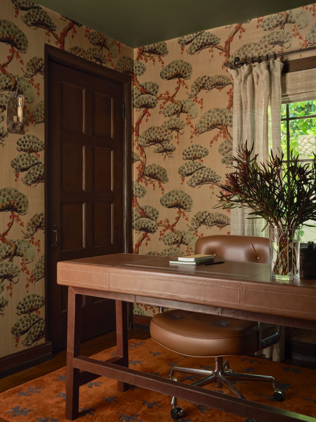 Home office with botanical wallcovering and Eames executive chair at wood desk in Palo Alto Silicon Valley California Mediterranean house designed by Mandy Cheng