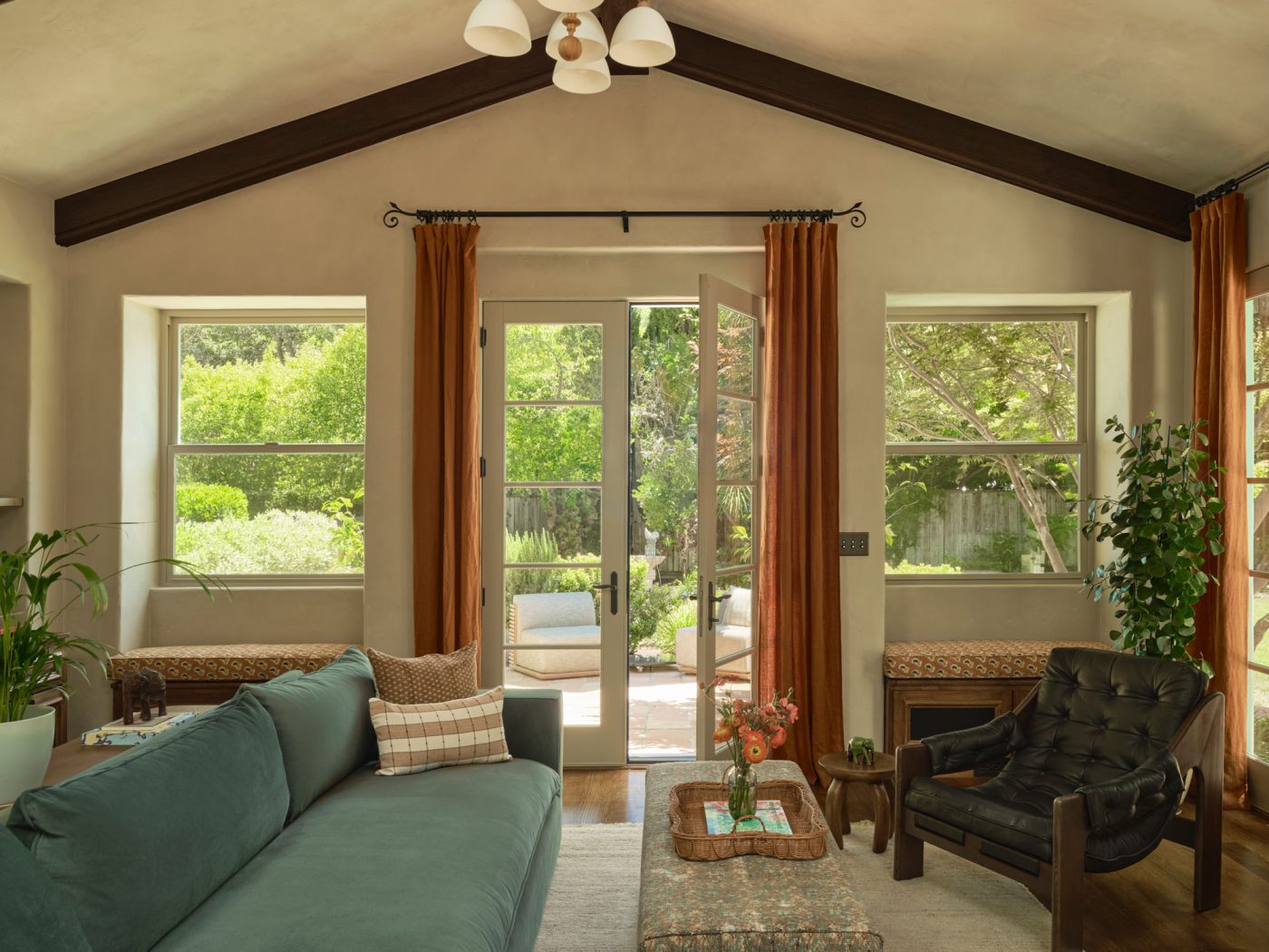 Family room with light teal sofa and slouchy leather chair in Palo Alto Silicon Valley California Mediterranean house designed by Mandy Cheng