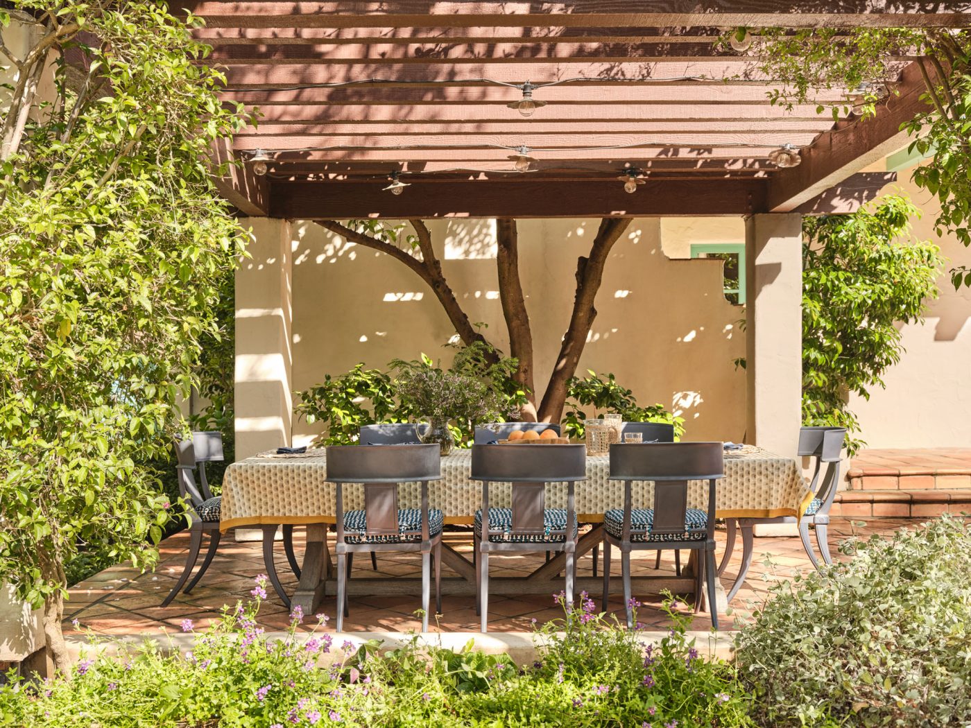 Pergola covered dining terrace in garden of Palo Alto Silicon Valley California Mediterranean house designed by Mandy Cheng