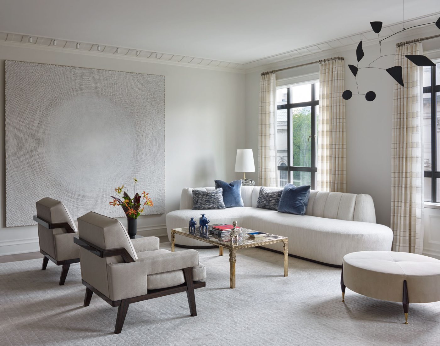 Living room with Alexander Calder mobile from ceiling in Fifth Avenue Manhattan apartment designed by David Kleinberg