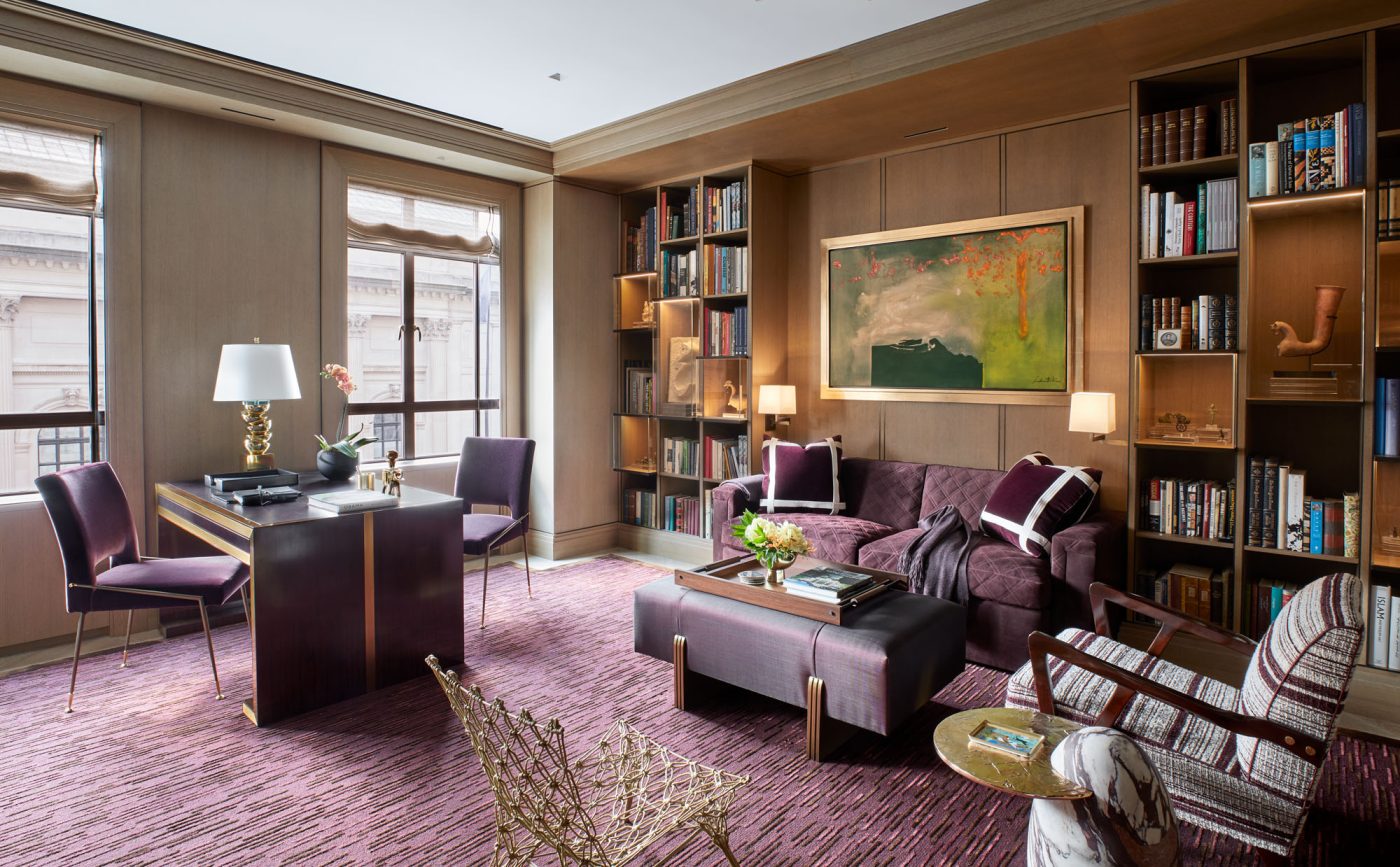 wood paneled library with burgundy accents and Helen Frankenthaler painting in Fifth Avenue Manhattan apartment designed by David Kleinberg