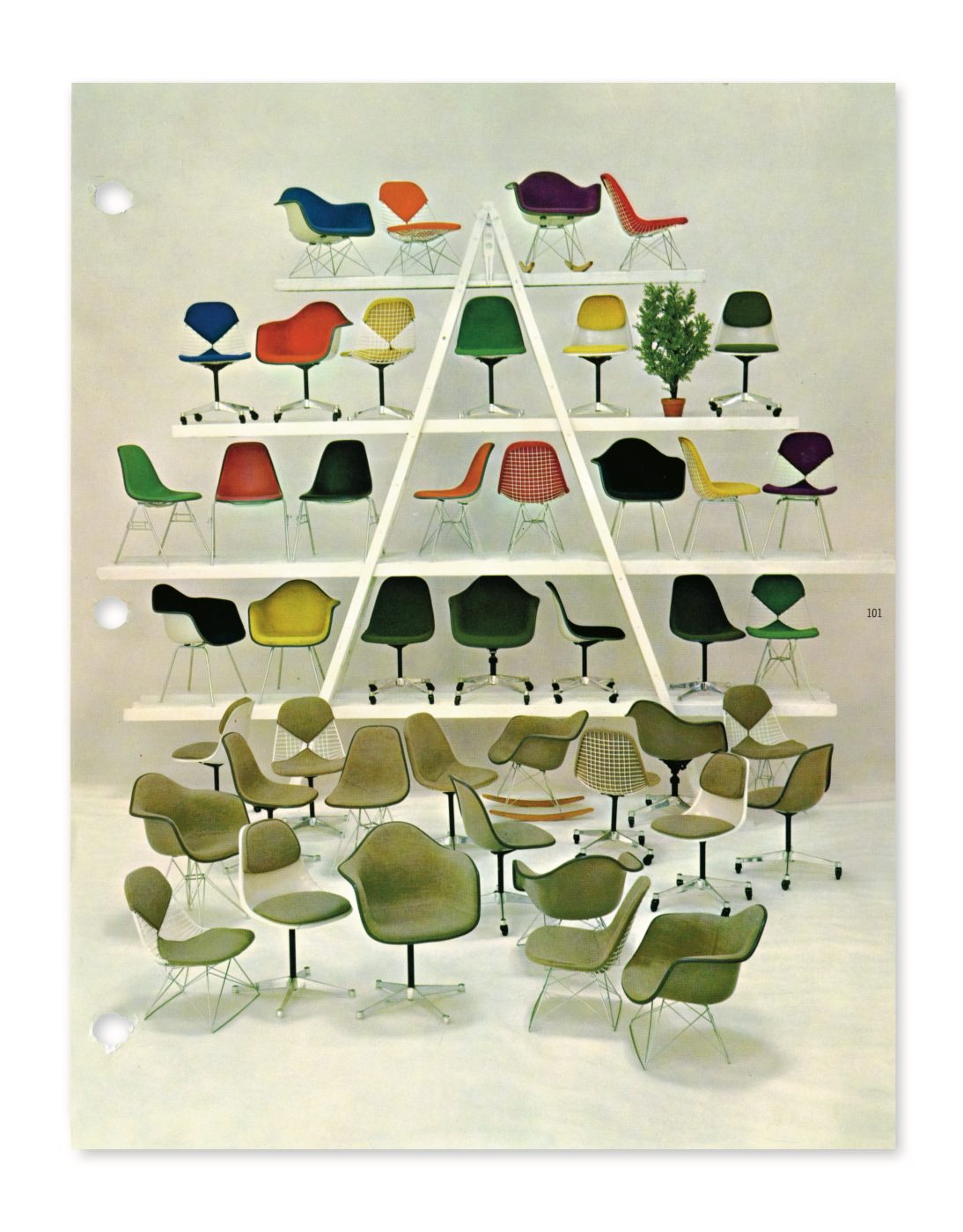 A pyramid-shaped shelving unit holding chairs designed by Charles and Ray Eames, with many more Eames chairs arrayed in front of it