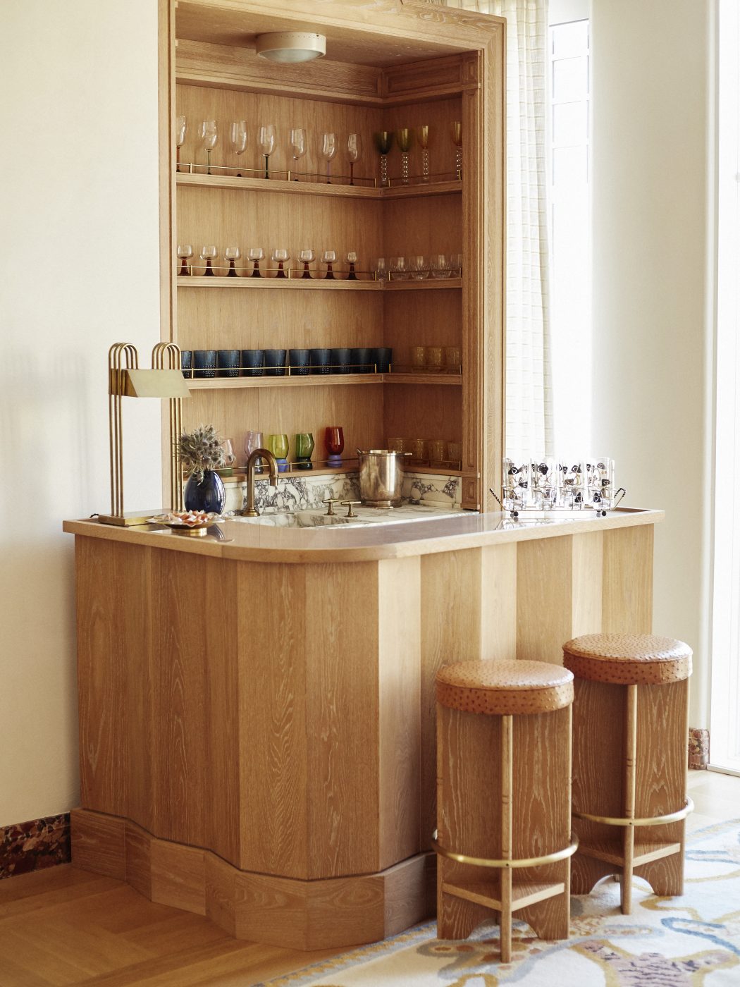 Custom oak bar with ostrich-leather-upholstered stools in a house in Brooklyn's Gravesend neighborhood with interior design by Eli Dweck 