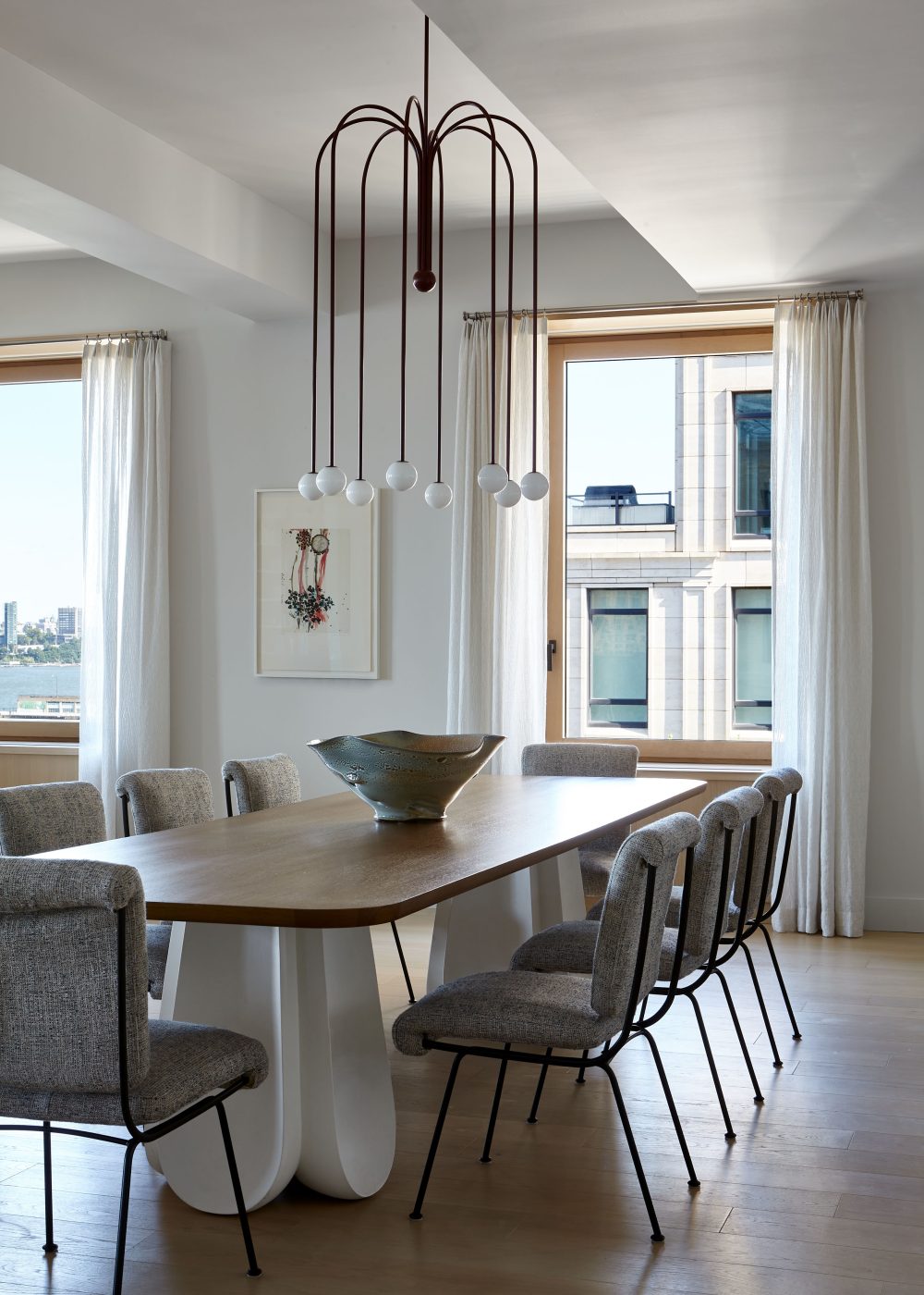 Dining area with Michael Anastassiades chandelier, Emmanuel Levet Stenne dining table with a plaster base and oak top, surrounded by reeditions of Gastone Rinaldi's Mod Du 24 chairs in Tribeca Manhattan New York loft designed by Damon Liss