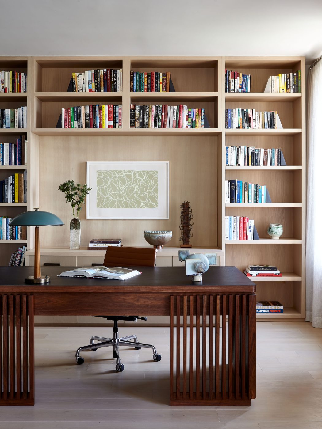 Dining area with Michael Anastassiades chandelier, Emmanuel Levet Stenne dining table with a Home office with Böhlmarks table lamp from PRB Collection, walnut and leather Tim Vranken desk in Tribeca Manhattan New York loft designed by Damon Liss