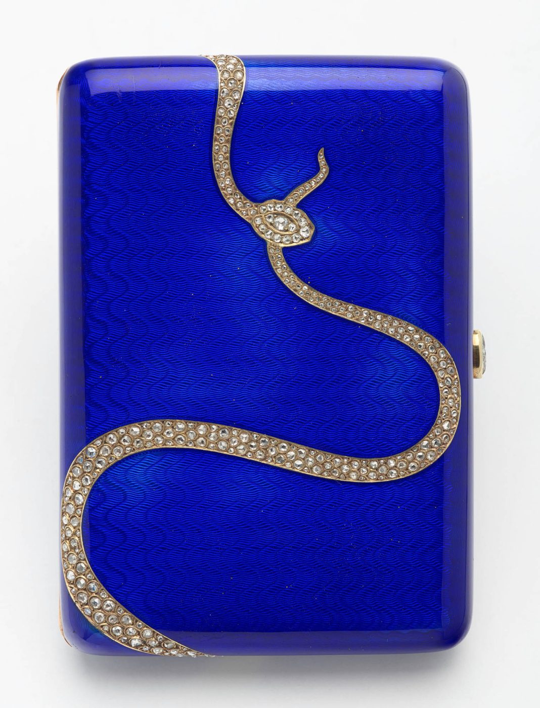 A blue-enamel Fabergé cigarette case with a diamond-studded snake design