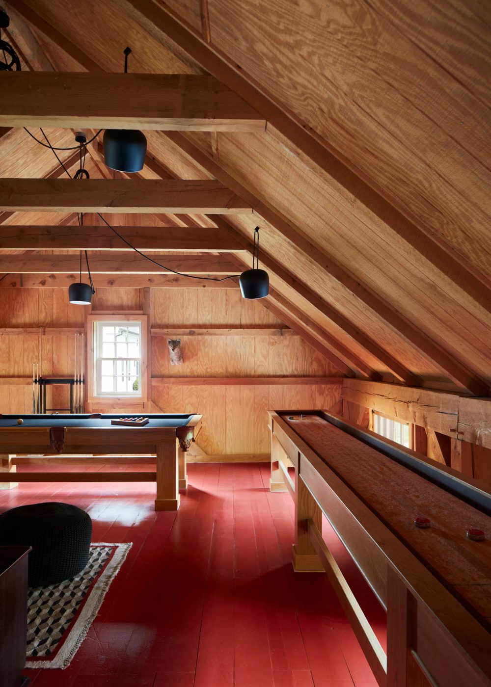 Upstairs, Shawn Henderson created a game room and lounge with a custom pool table and 22-foot-long shuffleboard.