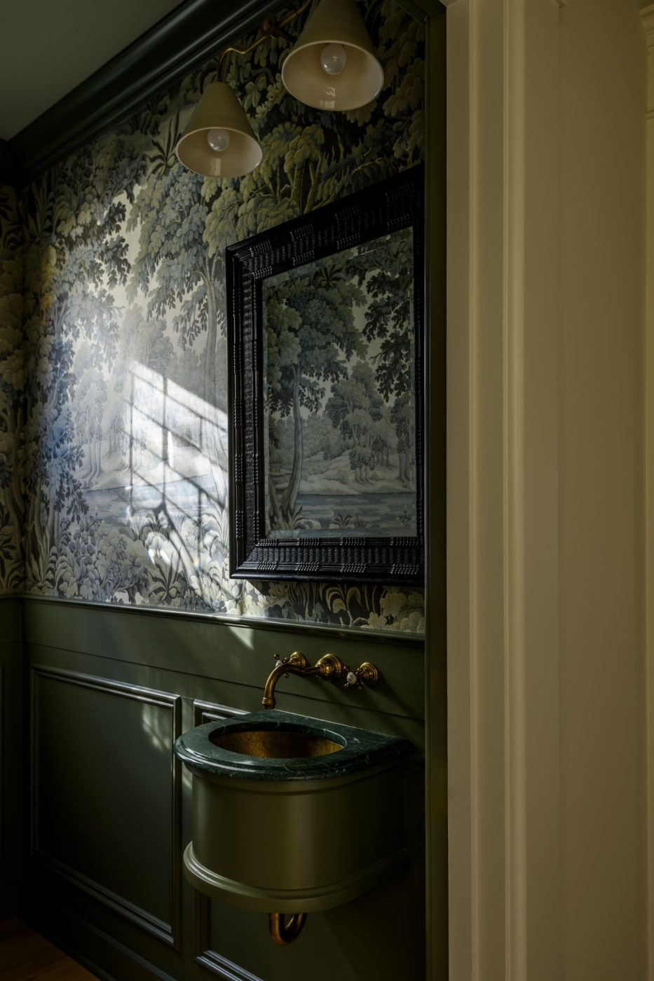 Powder room with with moody botanical scenic wallpaper n a house in Seattle's Capitol Hill neighborhood designed by Lisa Staton