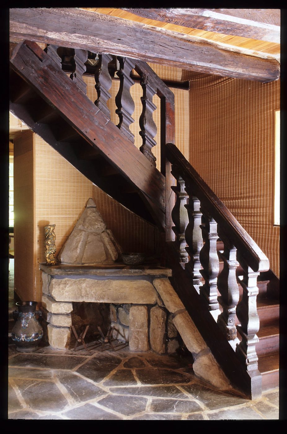 A staircase and fireplace in Jean Royère's home in Brittany