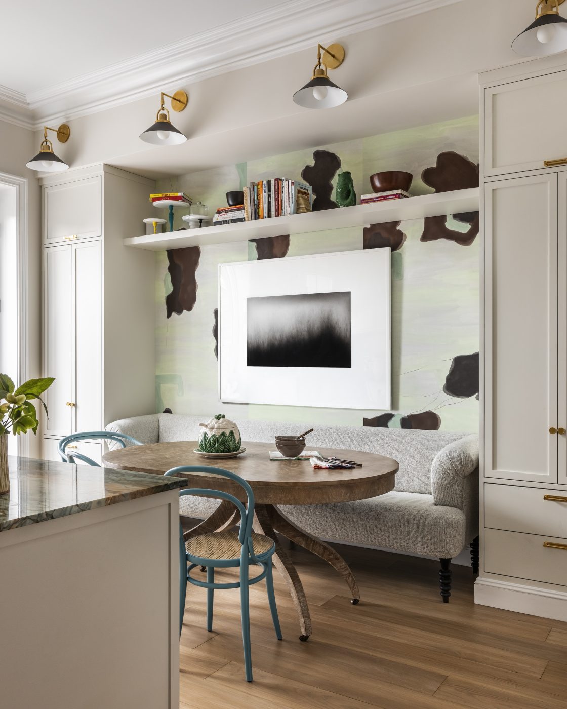 The family eats in a dining nook with Thonet-style cafe chairs around a bleached-mahogany table.