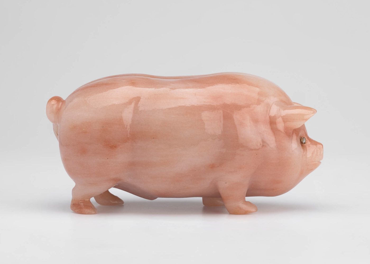 A Fabergé sculpture of a pig carved from pink aventurine quartz and set with diamonds for eyes