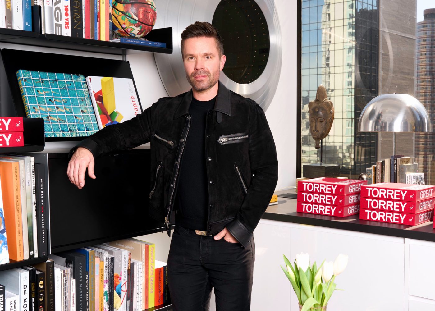 Andrew Torrey poses with his debut monograph Torrey: Private Spaces, Great American Design.