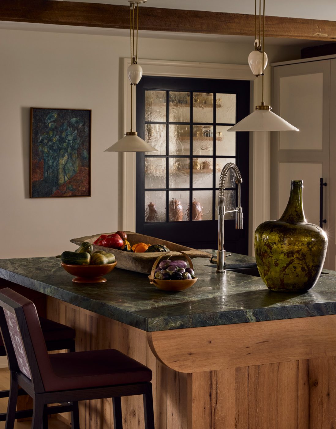 Above the kitchen's dining island are adjustable-height pulley lights by Hector Finch.