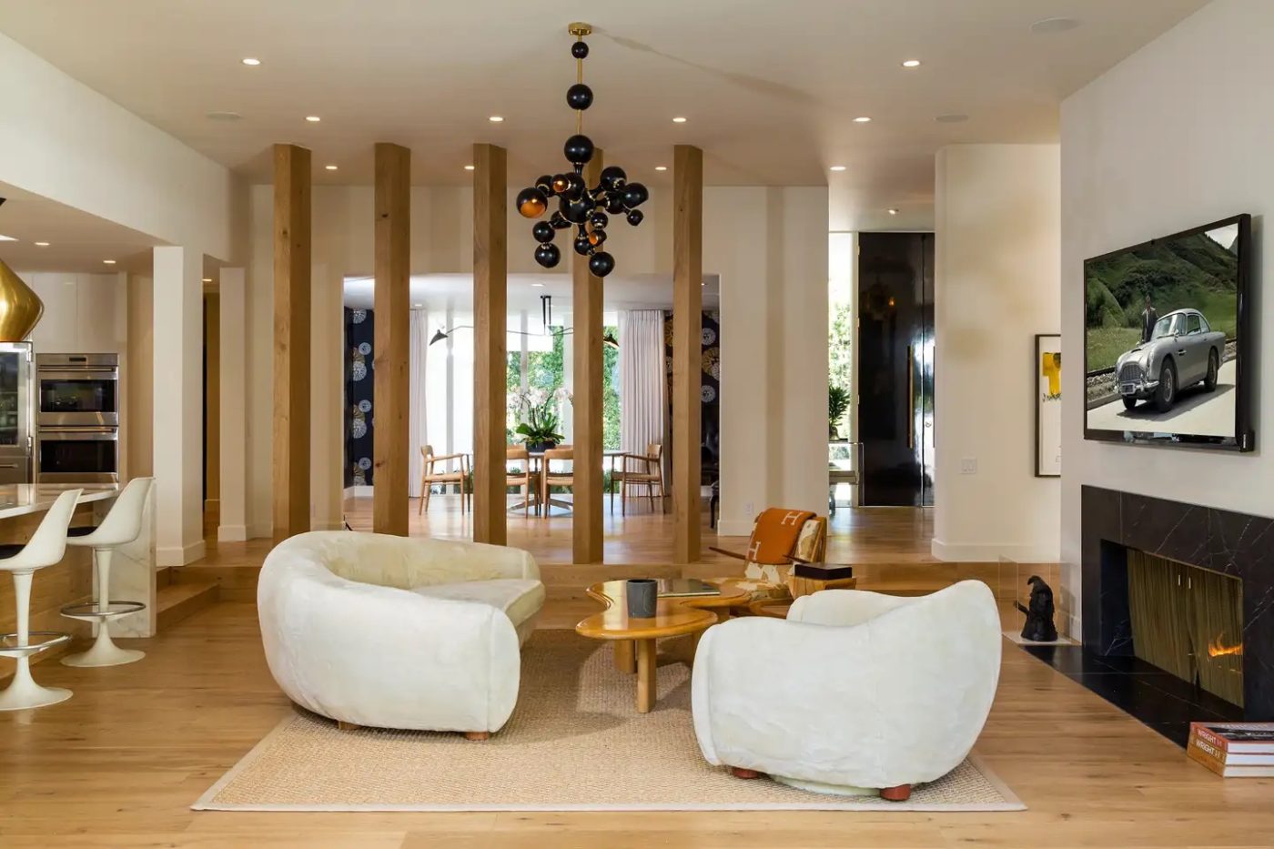 A pair of Polar Bear chairs in front of the fireplace in a Beverly Hills residence designed by Trip Haenisch