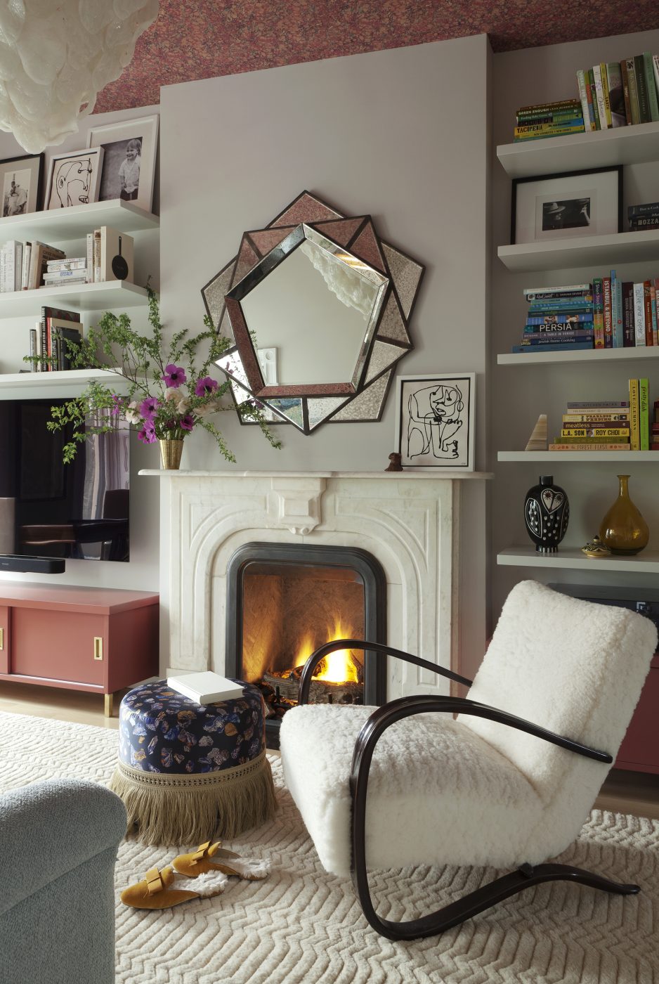 Occupying the entire top floor, the primary suite includes a sanctuary-like sitting room with such vintage furnishings as a modern low-back sofa, a 1930s Jindřich Halabala H269 armchair for Thonet and Karl Springer parchment side chairs, which are paired with a ’40s French game table next to the windows. 
