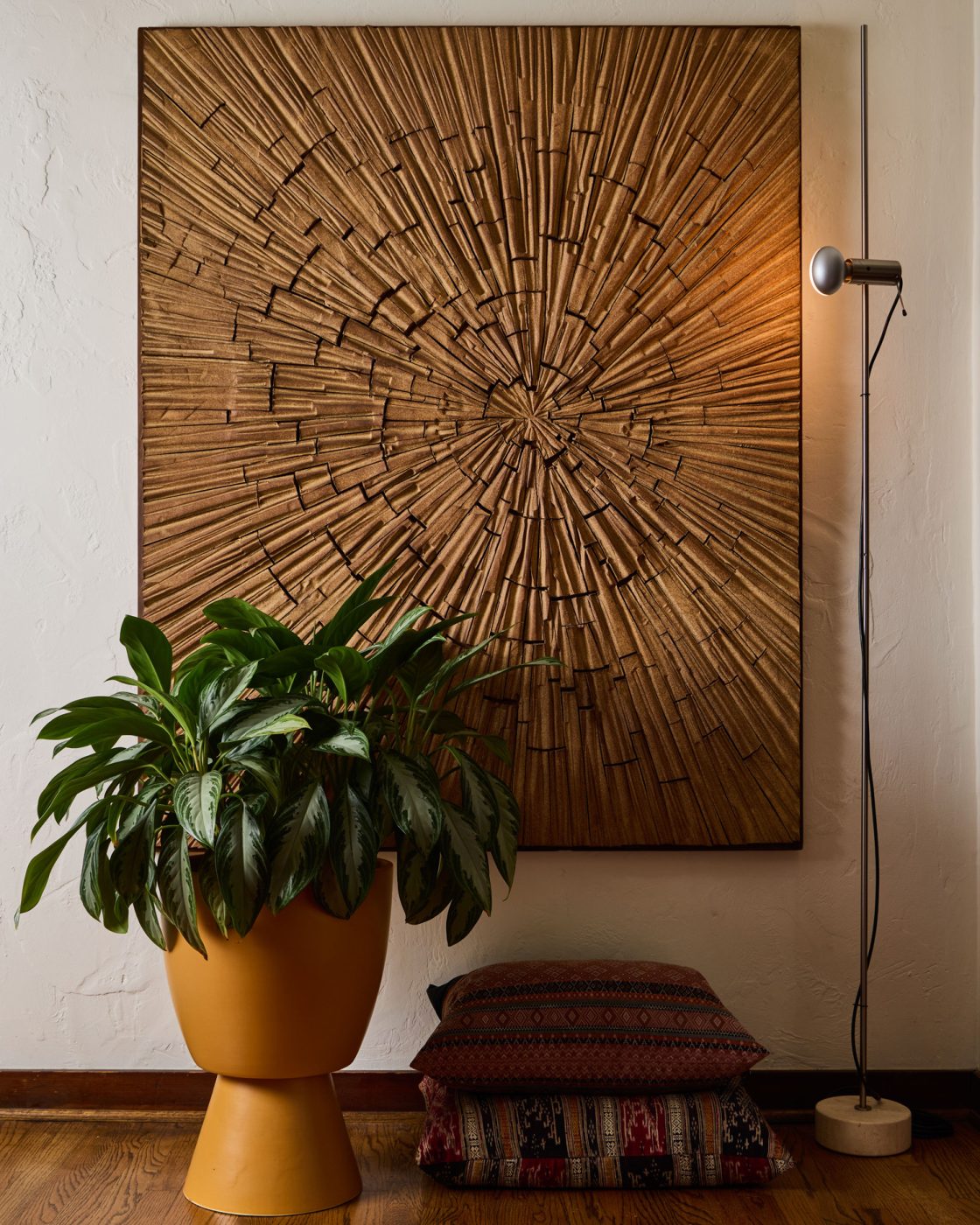 Vignette with Robert Maxwell wall sculpture, lamp and yellow pottery