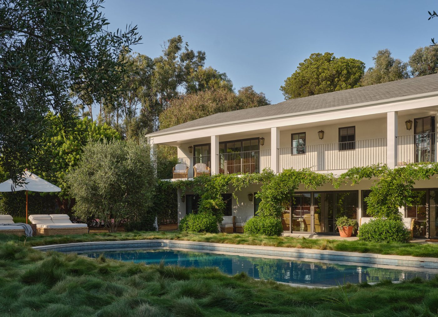 Rear exterior, garden and pool of Malibu California home of interior designer Sarah Solis 