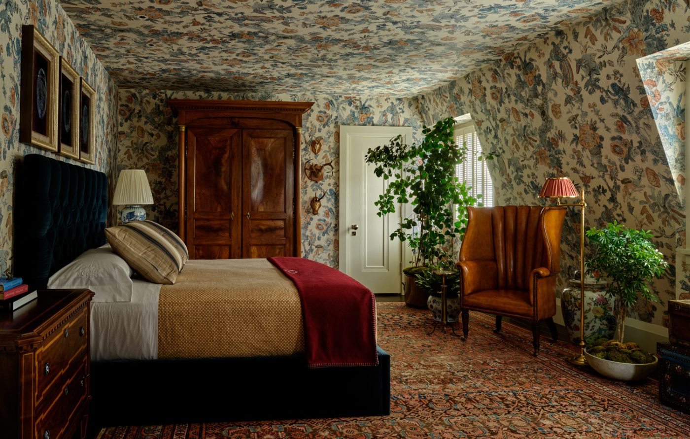 Top-floor guest room with allover botanical wallpaper and antiques in Edwardian house San Francisco's Pacific Heights with interiors by Brittany Giannone's ABD STUDIO