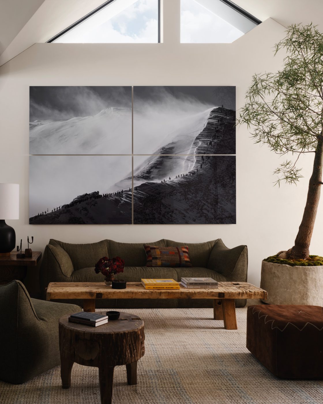 upstairs lounge of a house designed by Vanessa Alexander in Aspen, Colorado, featuring a Mario Bellini Le Bambole sofa and chair, a 20th-century bleached-raw-oak coffee table, a pouf from Henry Beguelin and an artwork by Guadalupe Laiz.