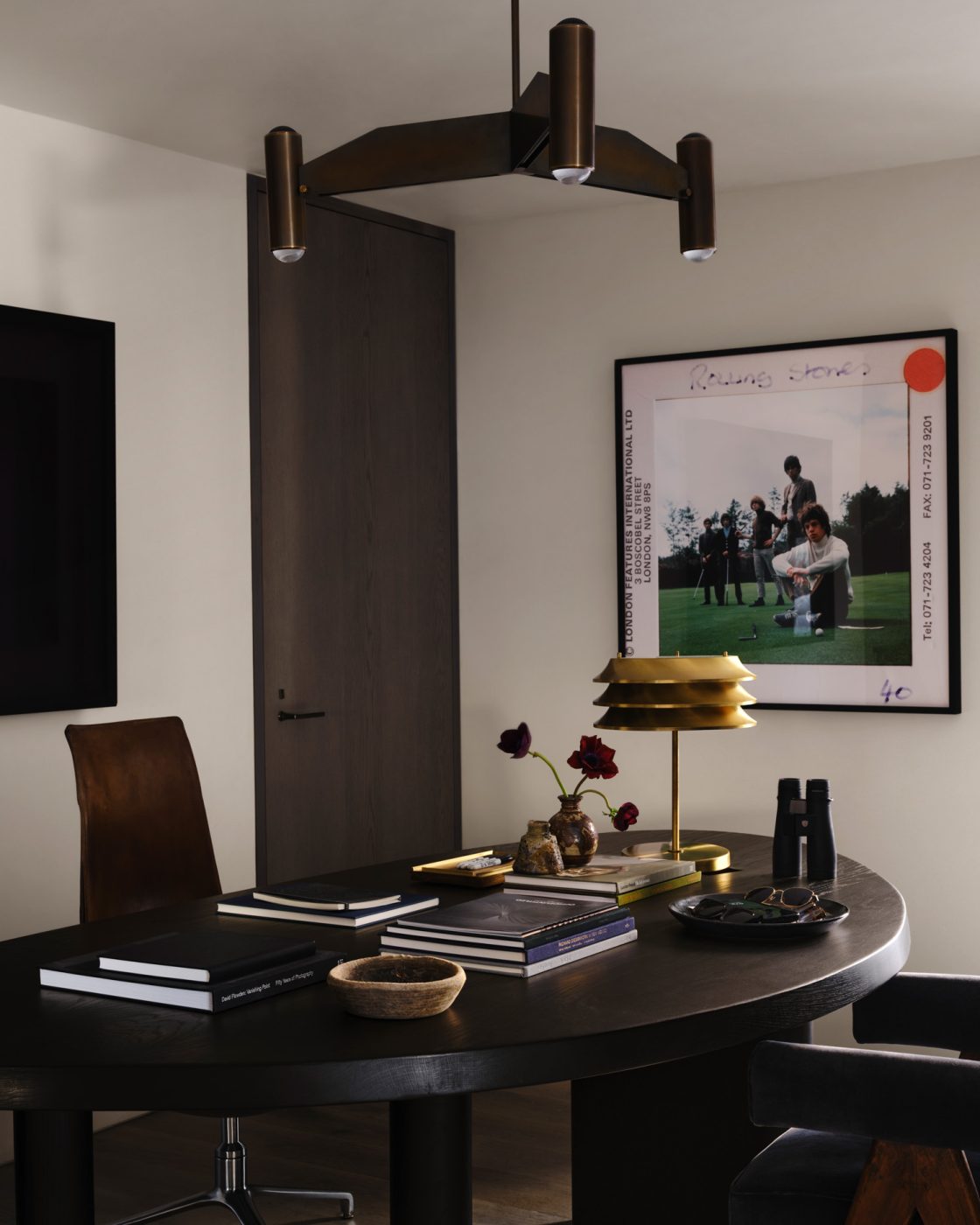 office study of a house designed by Vanessa Alexander in Aspen, Colorado, featuring an ebonized-oak desk with an oblong top, paired with a vintage bird chair. The desk lamp is by Kai Ruokonen.