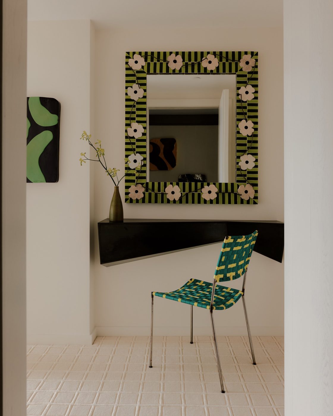 Entry hall in nearly all white minimalist loft apartment in New York's West Village  designed by Clive Lonstein and featuring a Franz West chair at an Angela Brown console under a custom mirror made in Morocco.
