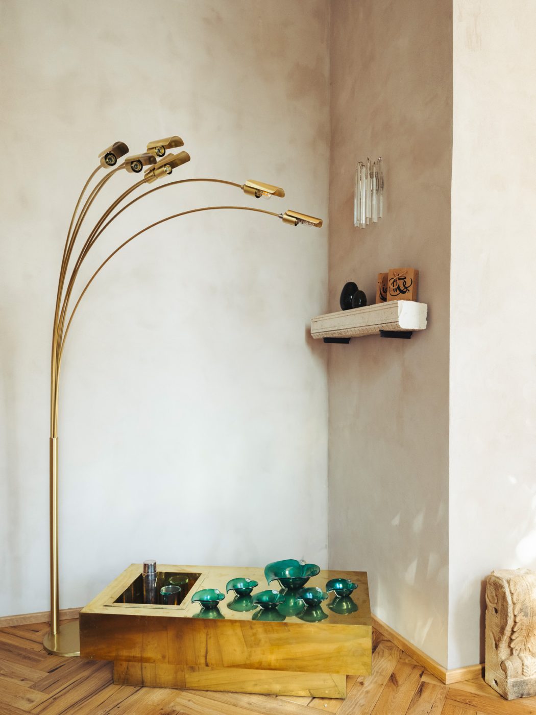 Arching brass 6-light floor lamp over polished brass Gabriella Crespi coffee table holding aquamarine-colored Murano glass bowls and cups by Alfredo Barbini at the Italian Collector, the Florence Italy shop of antiques dealer Bec Astley Clarke