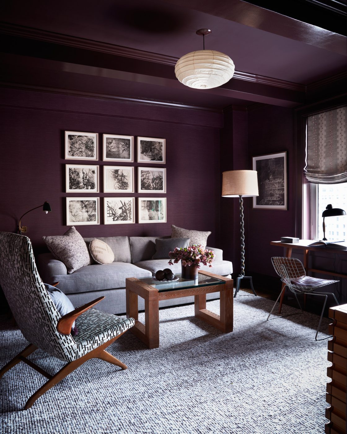 Egplant-colored office-sitting room-guest bedroom with sleeper sofa in an apartment on New York's Upper East Side designed by Erik Gensler