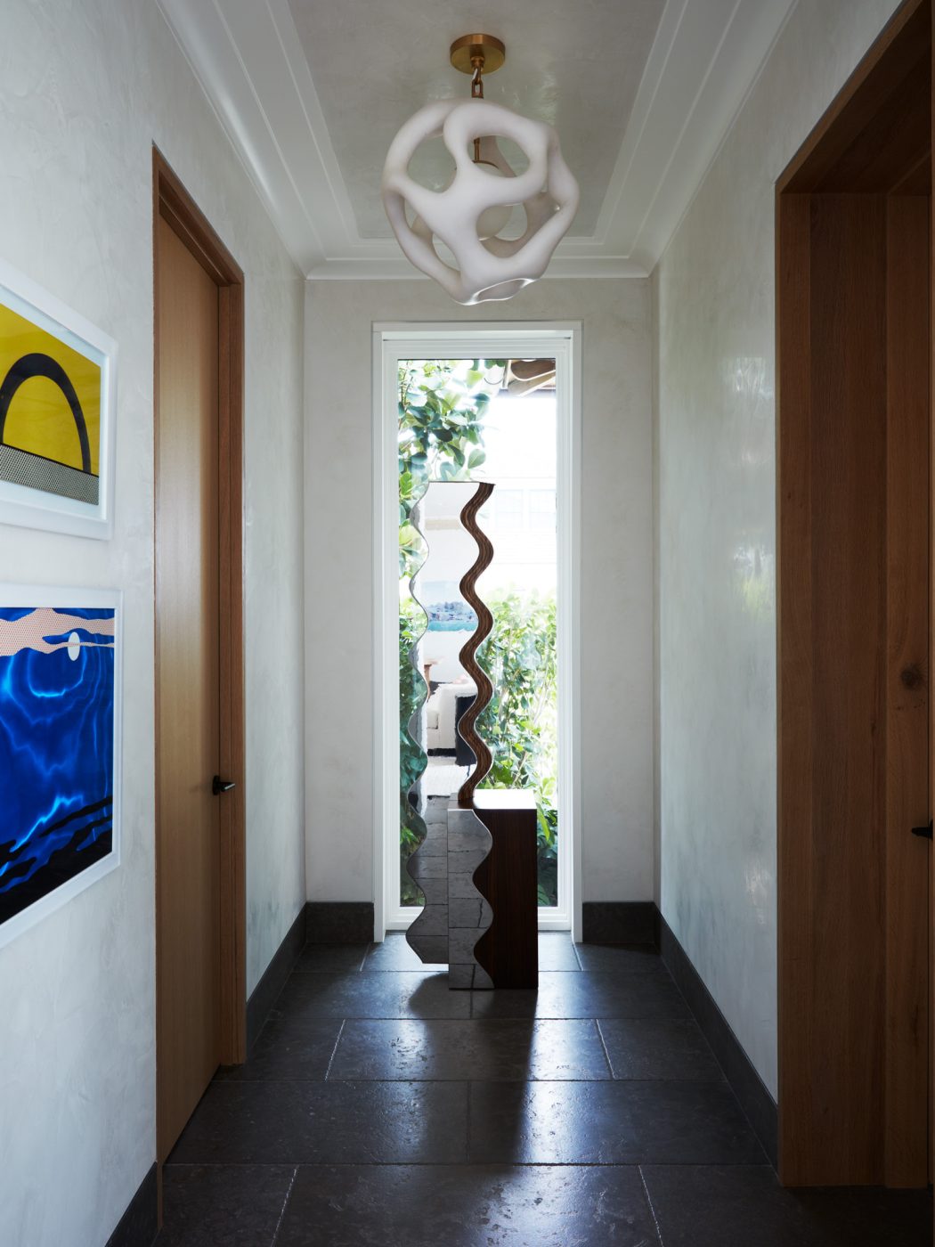 Hallway outside library in dining area of great room of West Palm Beach house with architecture by Daniel Kahan of Smith and Moore Architectures and interiors by Caroline Rafferty