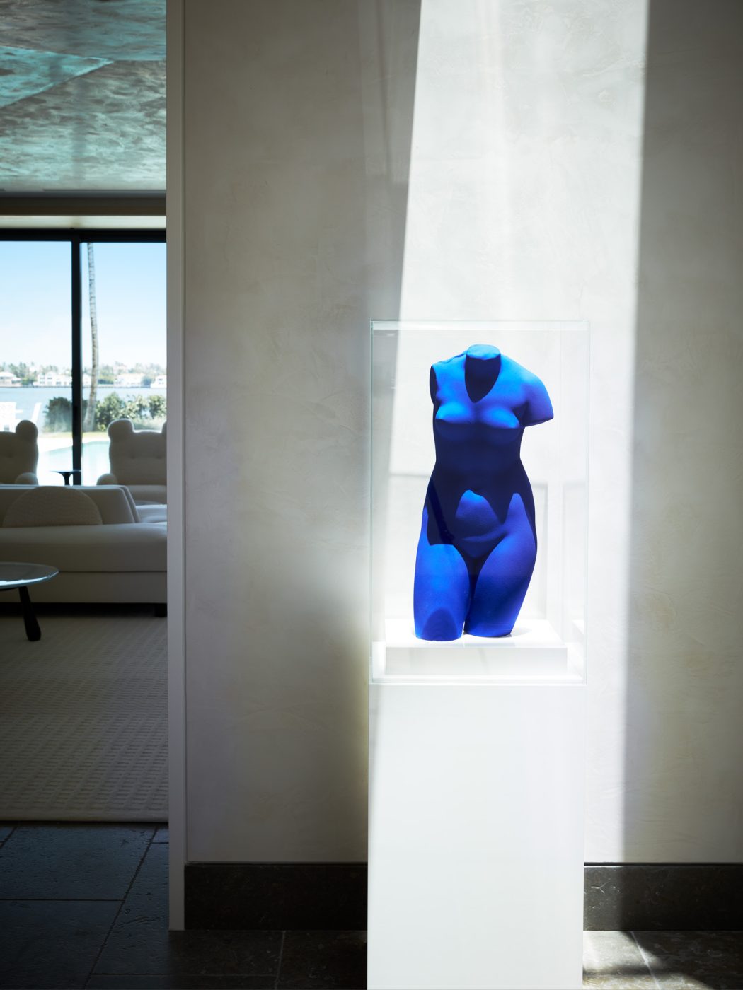 Close up of women's torso in blue by Yves Klein in West Palm Beach house with architecture by Daniel Kahan of Smith and Moore Architectures and interiors by Caroline Rafferty