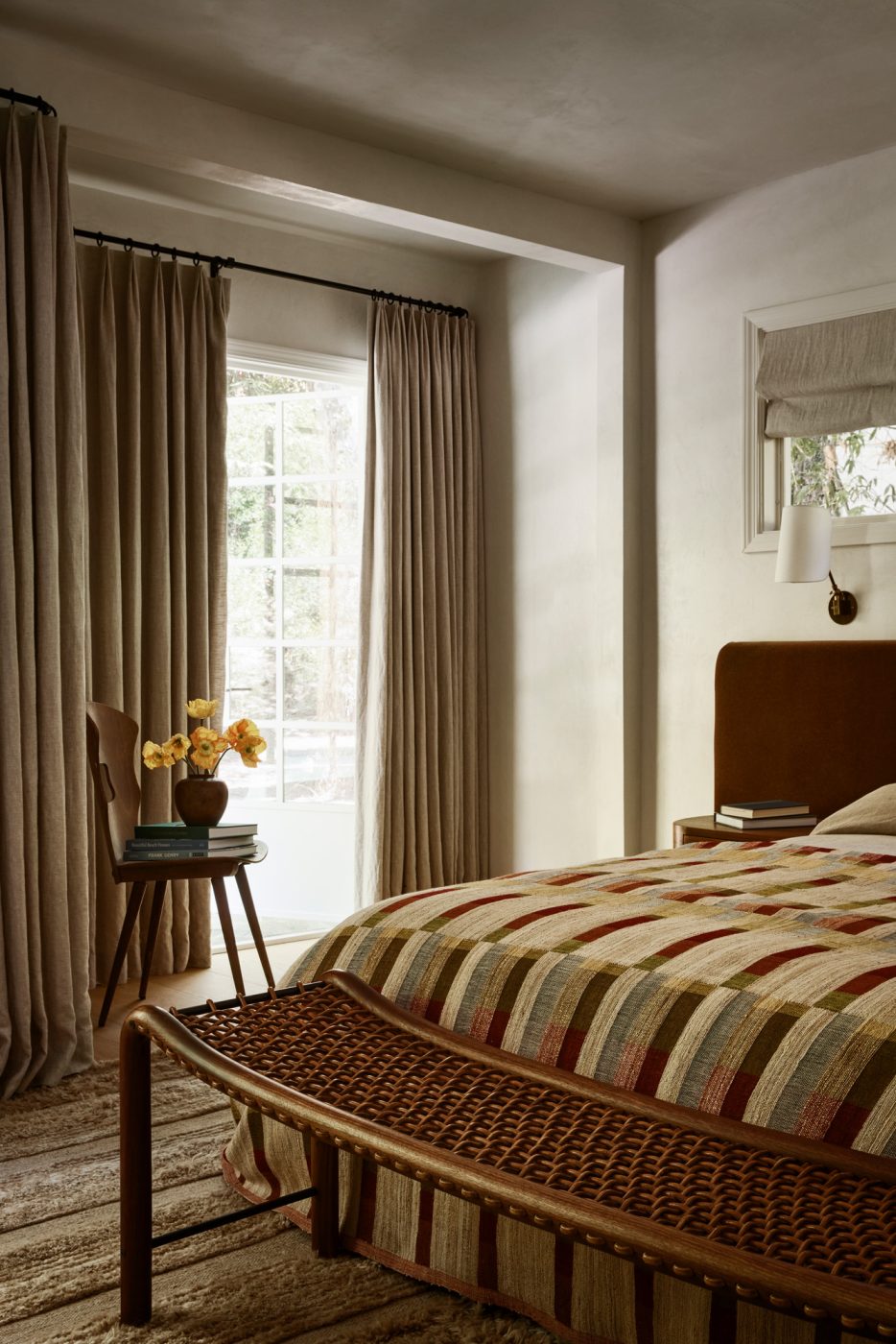 Primary bedroom in Beverly Hills home designed by Maggie Smith with a vintage William Emmerson bench at the foot of the bed