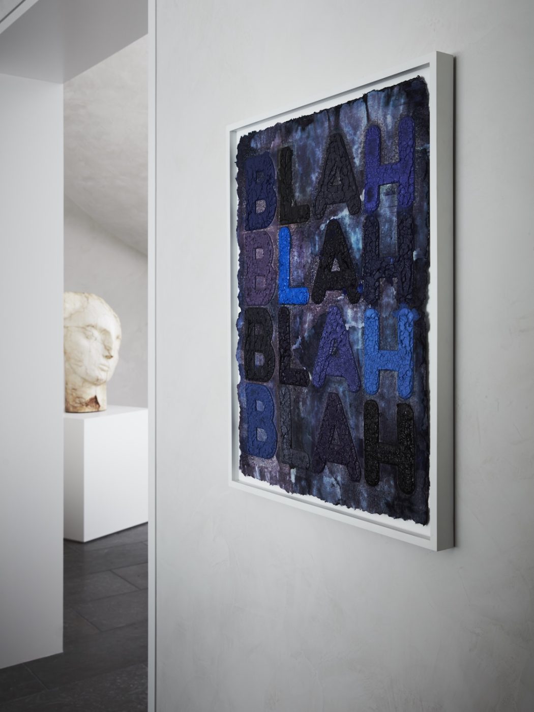 Close up of Mel Bochner Blah Blah Blah Blah word art in dining area of great room of West Palm Beach house with architecture by Daniel Kahan of Smith and Moore Architectures and interiors by Caroline Rafferty