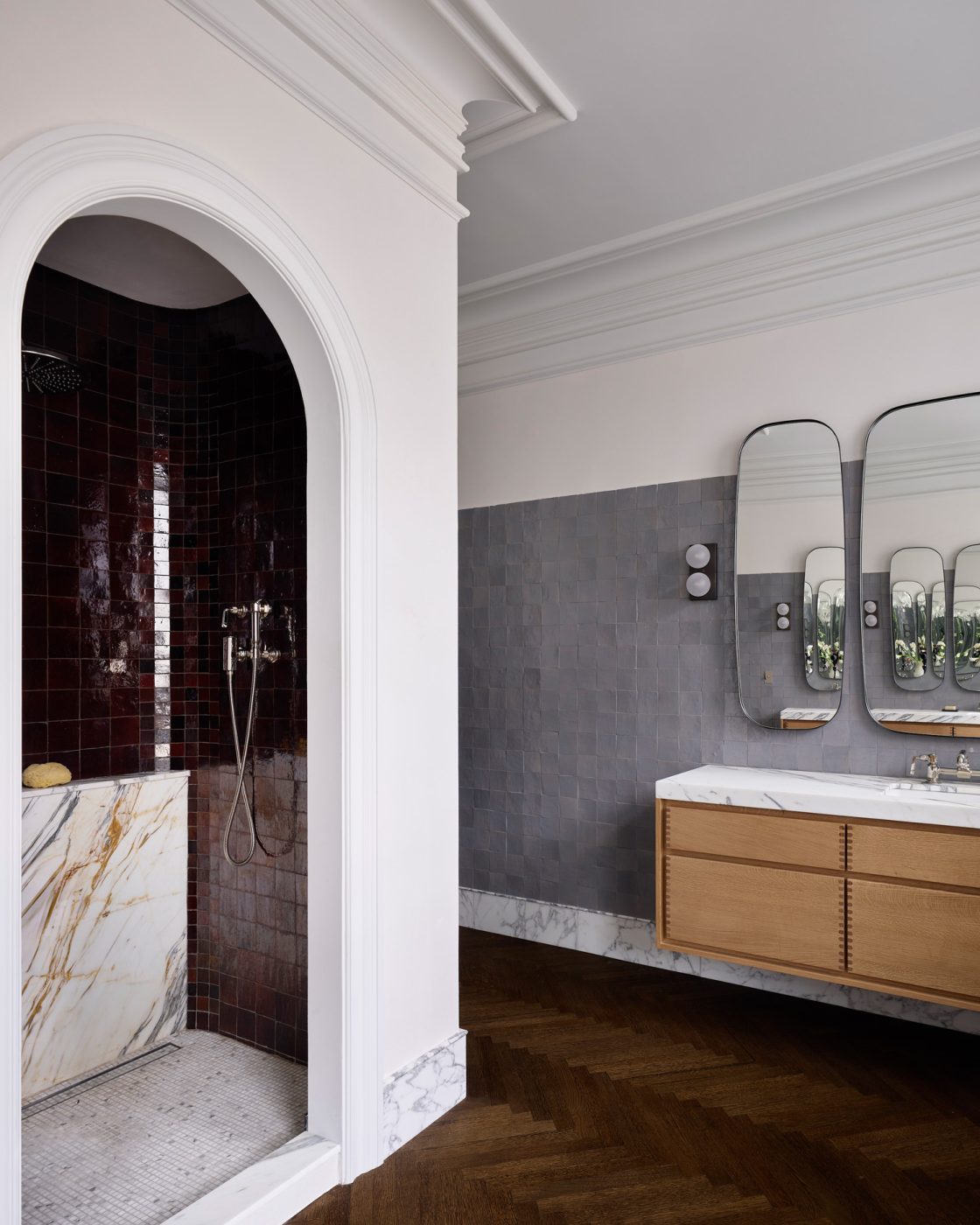 red-tiled shower alcove and floating vanity under trio of mirrors in a Harlem townhouse design by Crystal Sinclair
