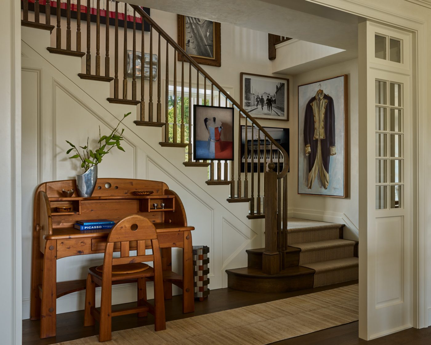Chunky wood WASA Mobel desk sourced via Lostine in stairhall of a recently finished vintage Colonial-style home redesigned by Autumn Oser and Andre Golsorkhi, partners in the design firm Haldon House