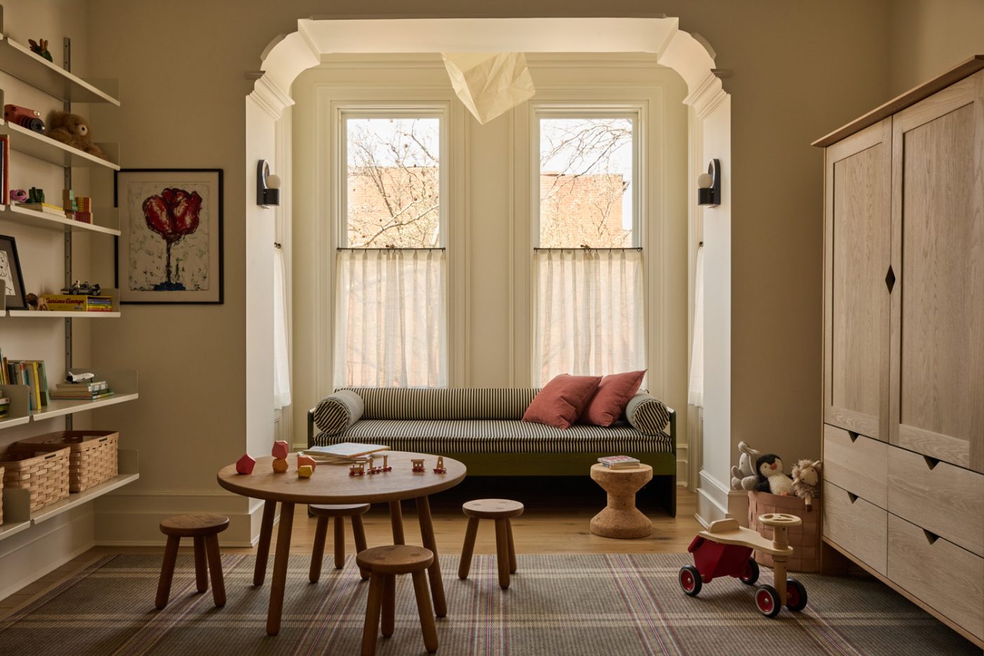 Playroom with Derk Jan de Vries daybed, Isamu Noguchi Akari light sculpture, Dieter Rams shelves and toys and kids table in Prospect Heights Brooklyn brownstone renovated by the interior design firm Jesse Parris-Lamb